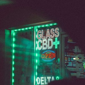a lighted sign that reads glass cbd plus